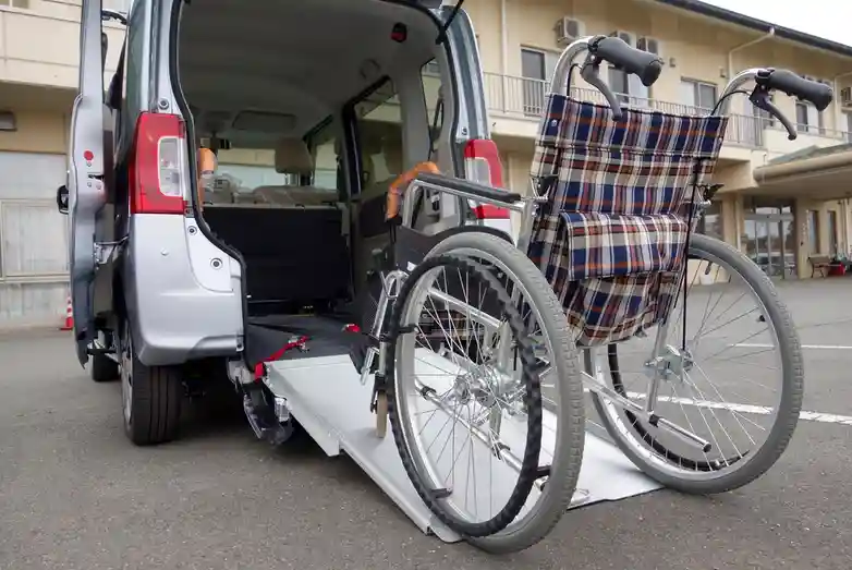 Senior entering medical transport vehicle